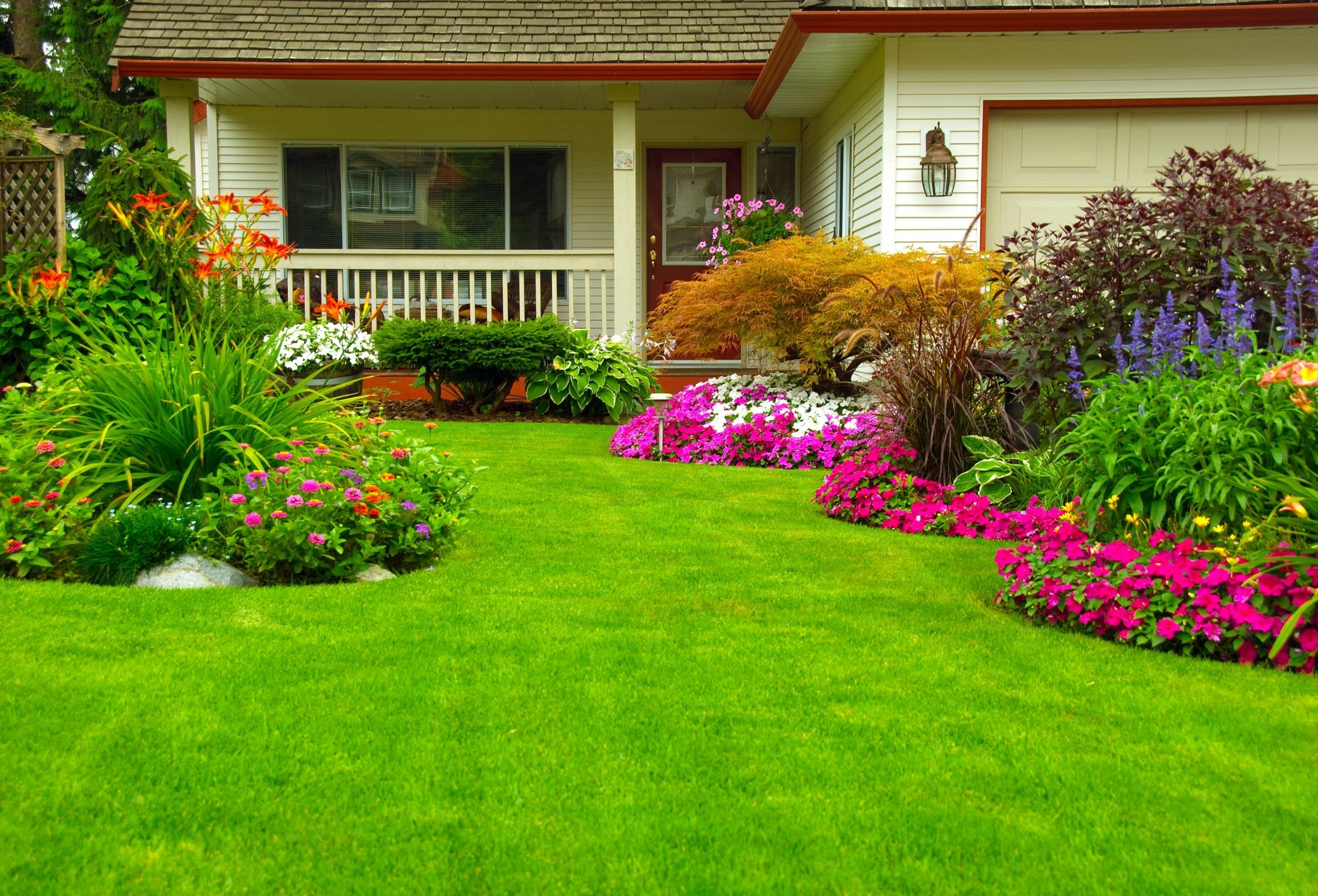 awn and garden care with freshly mowed grass, trimmed edges, and vibrant flower beds.