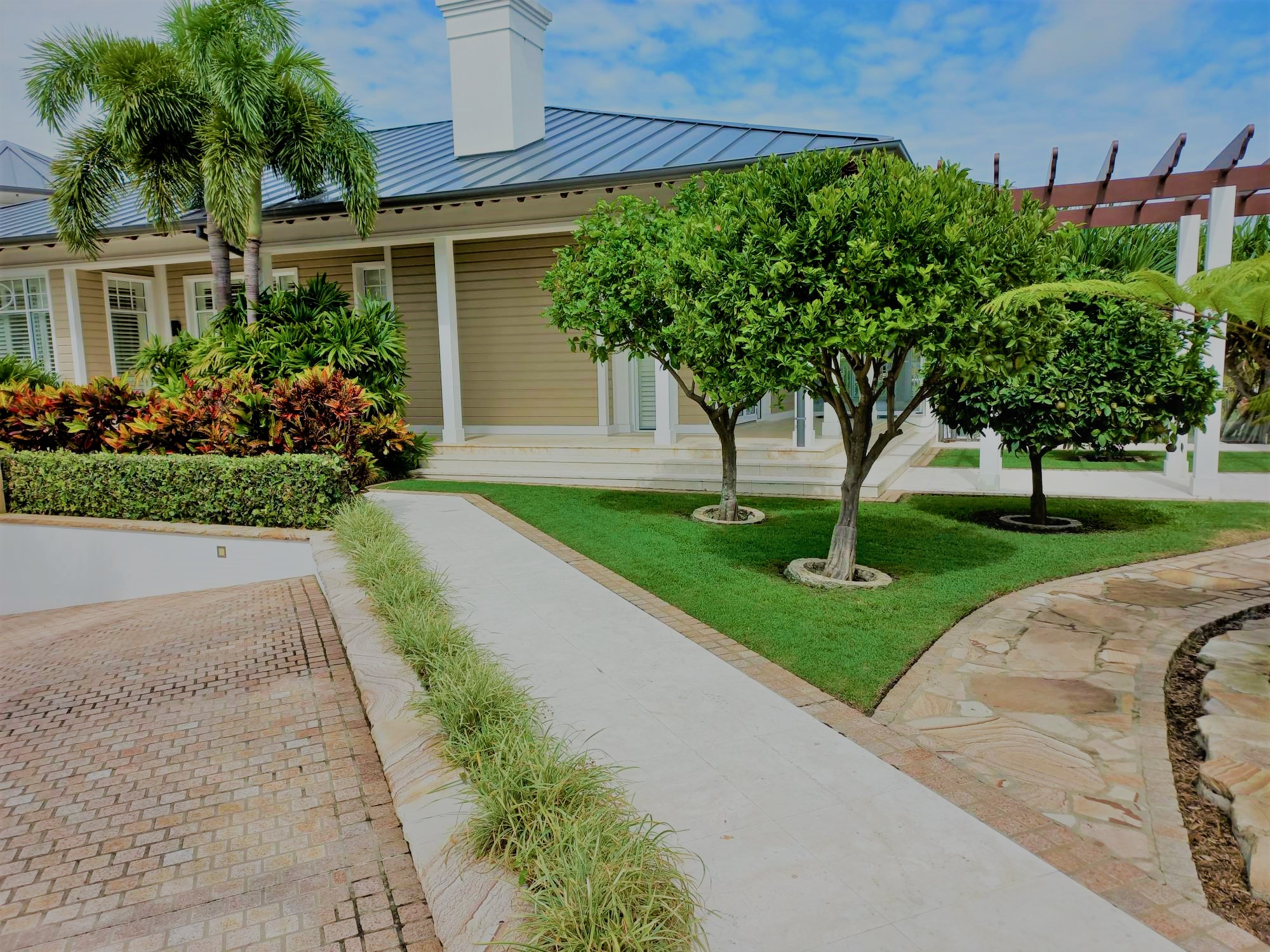 Executive property maintenance with manicured lawns, trimmed hedges, and pristine landscaped garden areas.
